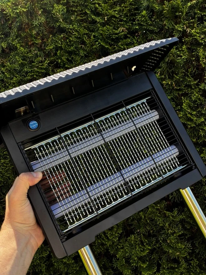 NovaVolt Solar bug zapper on a backyard deck at dusk